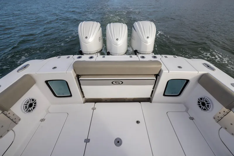 Slide: The Image of 2022 Sportsman Open 352 Center Console boat with triple outboard engines on water. - 36