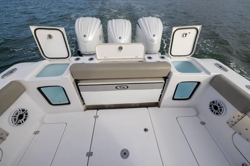 Slide: The Image of 2022 Sportsman Open 352 Center Console boat with triple engines and open storage compartments. - 37