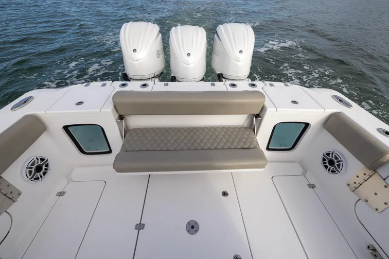 Slide: The Image of 2022 Sportsman Open 352 Center Console boat with triple engines and cushioned seating. - 38
