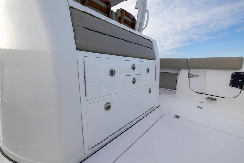 Slide: The Image of 2022 Sportsman Open 352 Center Console interior with storage compartments and seating. - 41