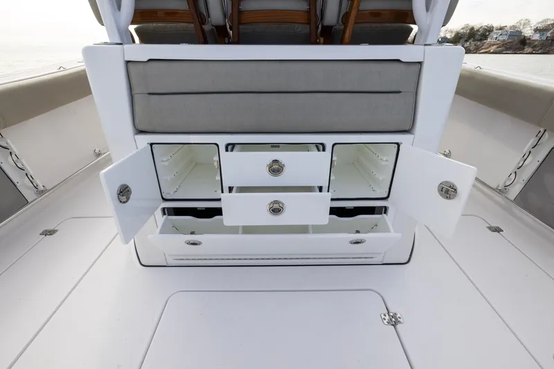 Slide: The Image of 2022 Sportsman Open 352 Center Console storage compartments open on deck. - 43