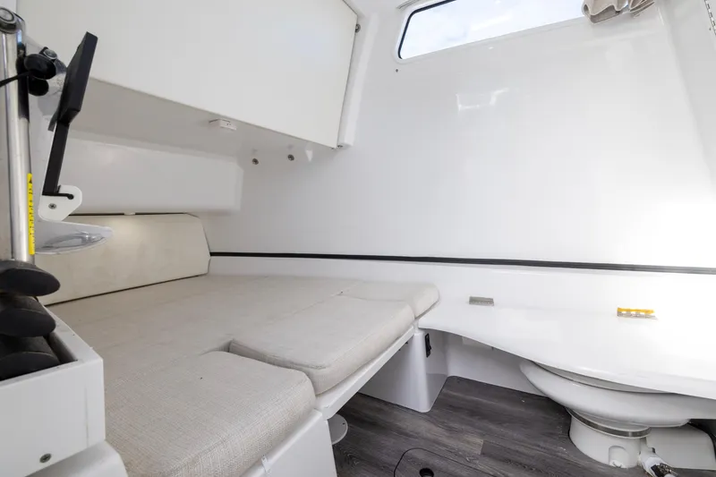 Slide: The Image of Interior cabin of 2022 Sportsman Open 352 Center Console boat, featuring a cushioned seating area. - 51