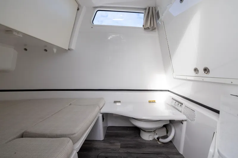 Slide: The Image of 2022 Sportsman Open 352 Center Console cabin interior with bed and toilet. - 53