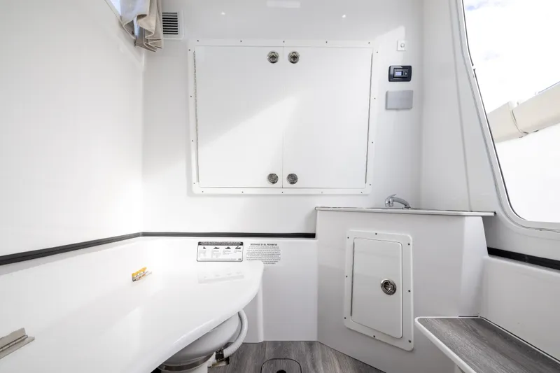Slide: The Image of 2022 Sportsman Open 352 Center Console interior with sink and storage compartments. - 55
