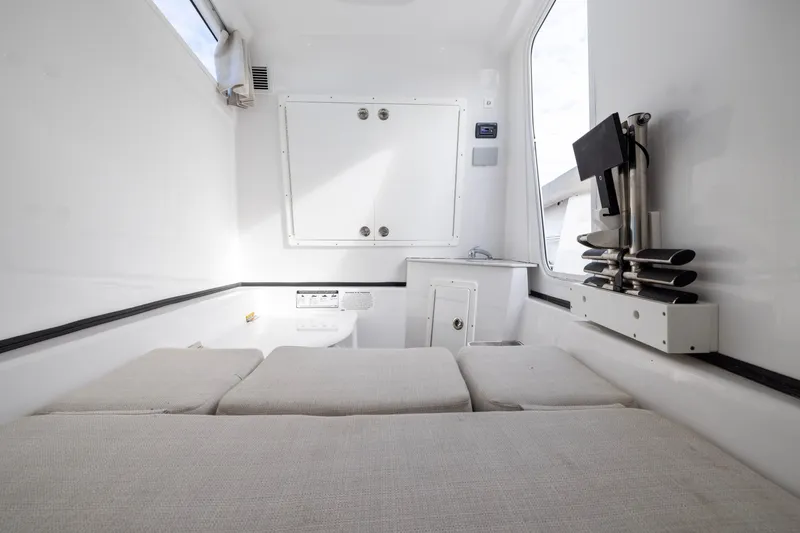 Slide: The Image of 2022 Sportsman Open 352 Center Console interior with cushioned seating and storage compartments. - 57