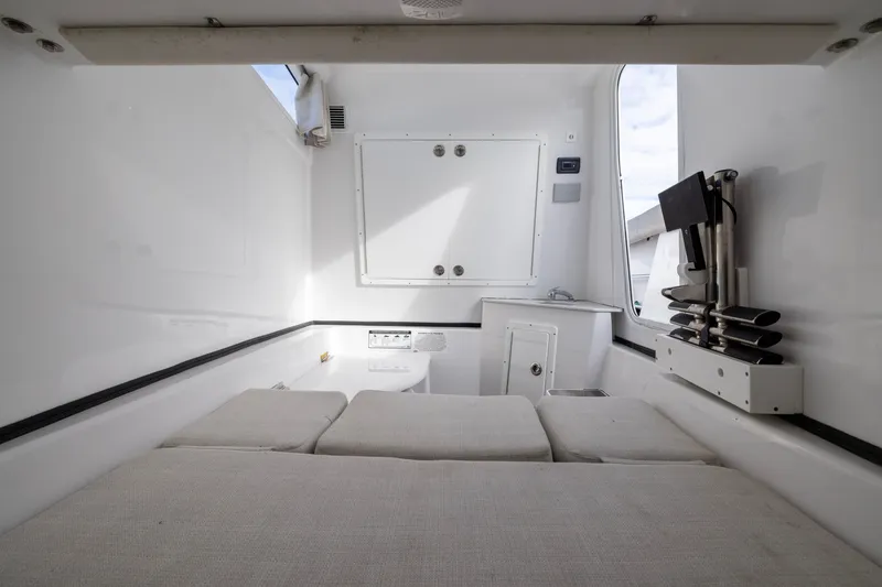 Slide: The Image of 2022 Sportsman Open 352 Center Console cabin interior with seating and storage. - 58