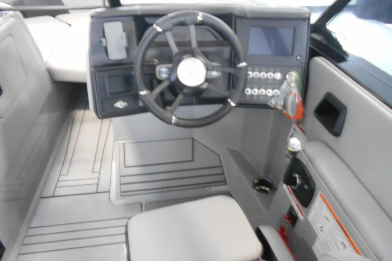 Slide: The Image of 2023 Moomba Max boat interior with steering wheel and control panel. - 14