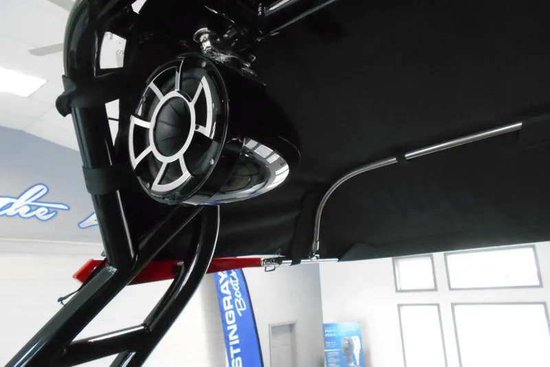 Slide: The Image of 2023 Moomba Max boat with sleek black speaker and canopy detail. - 23