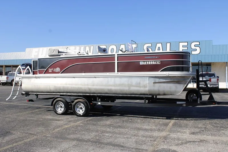 The Image of 2021 SunCatcher Select 22C pontoon boat on trailer at dealership parking lot. - 0