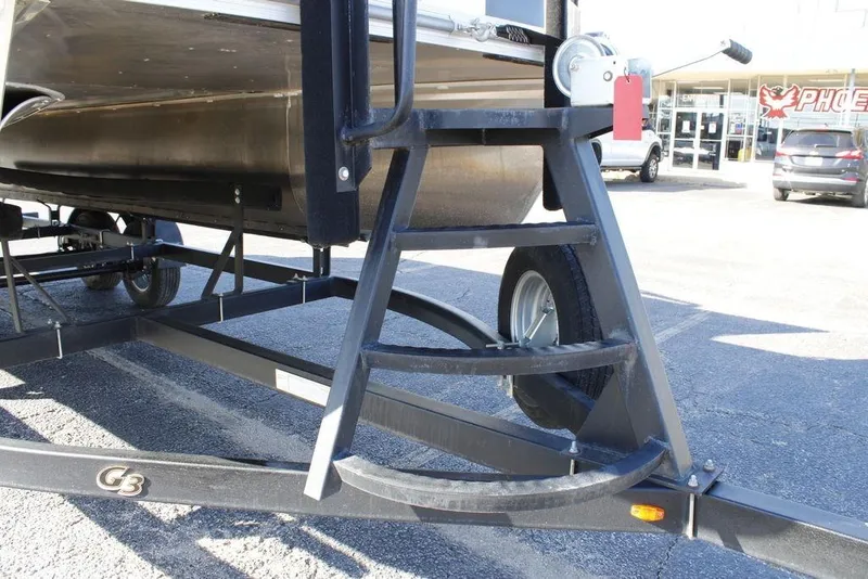 Slide: The Image of Trailer for 2021 SunCatcher Select 22C pontoon boat in parking lot. - 2