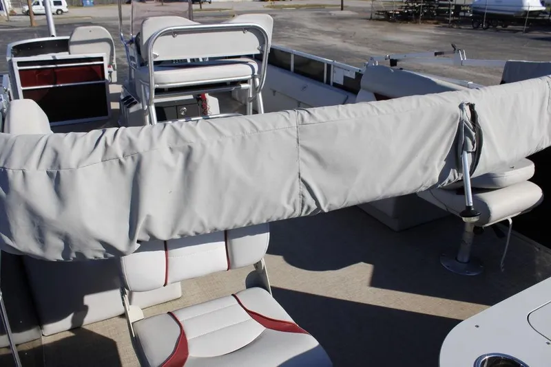 Slide: The Image of 2021 SunCatcher Select 22C pontoon boat interior with covered seating and helm. - 23