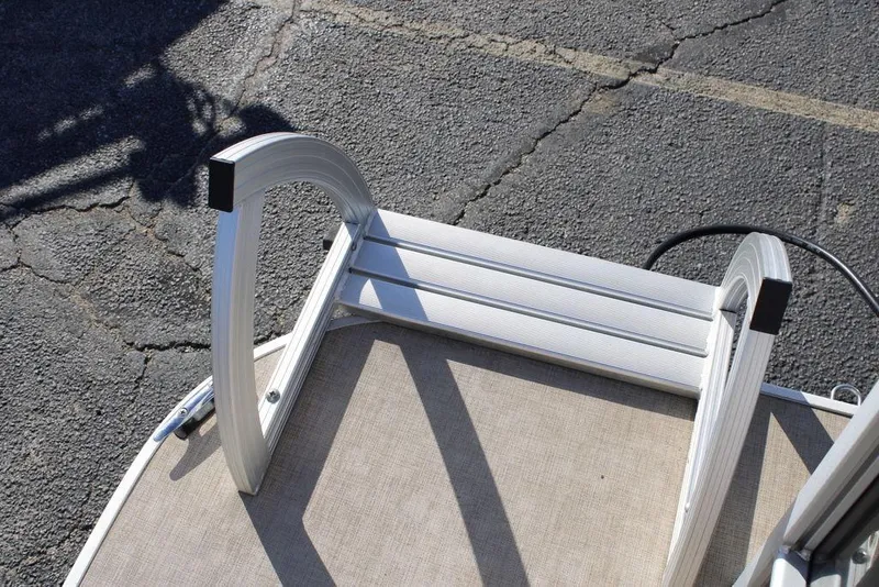 Slide: The Image of Aluminum ladder on 2021 SunCatcher Select 22C boat, resting on textured surface. - 29