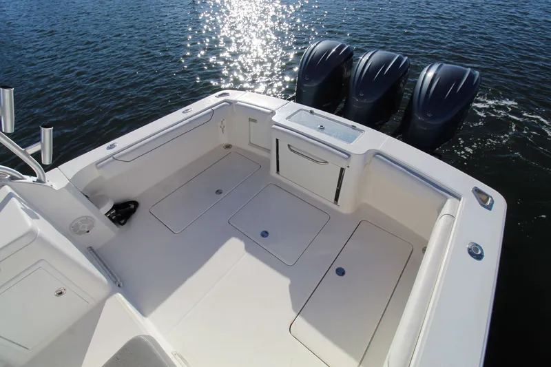 Slide: The Image of 2022 Albemarle 30 Express boat deck with triple outboard motors on water. - 17