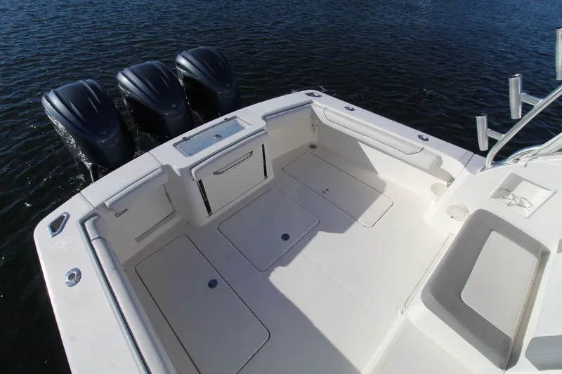 Slide: The Image of 2022 Albemarle 30 Express boat deck with triple outboard motors on water. - 18