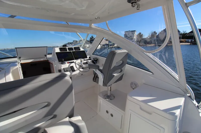 Slide: The Image of 2022 Albemarle 30 Express boat interior with helm, seats, and water view. - 24