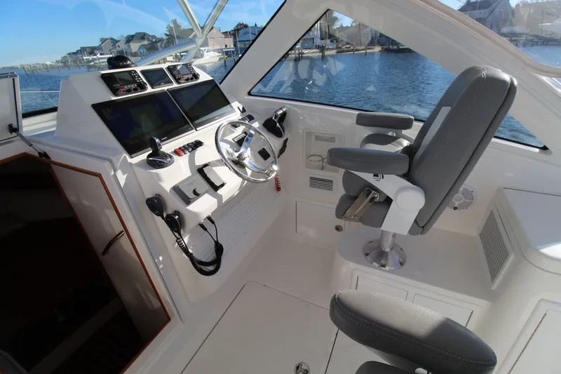 Slide: The Image of 2022 Albemarle 30 Express boat cockpit with modern controls and comfortable seating. - 25