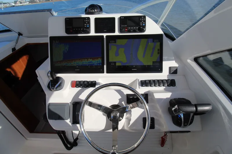 Slide: The Image of 2022 Albemarle 30 Express helm with dual Garmin displays and modern controls. - 26
