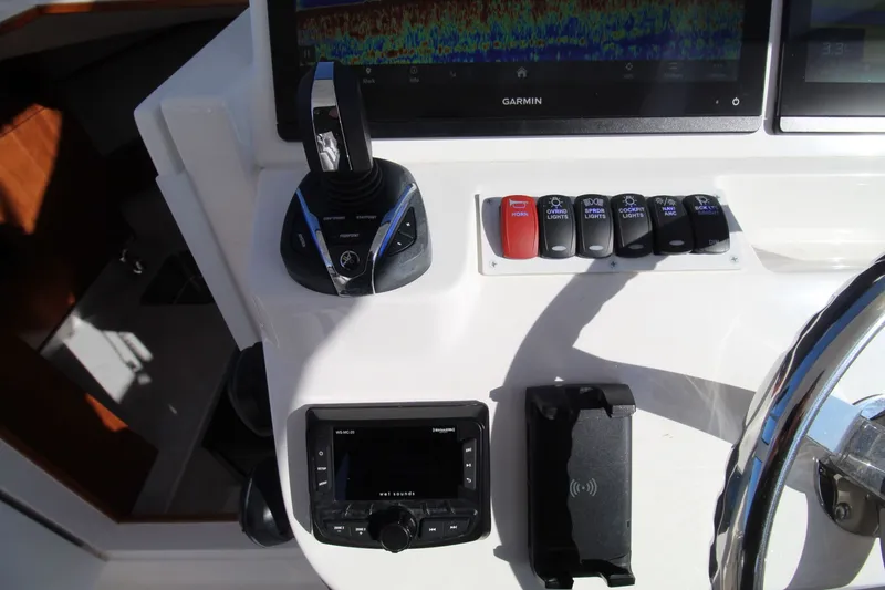 Slide: The Image of Control panel of 2022 Albemarle 30 Express boat with Garmin display and switches. - 27