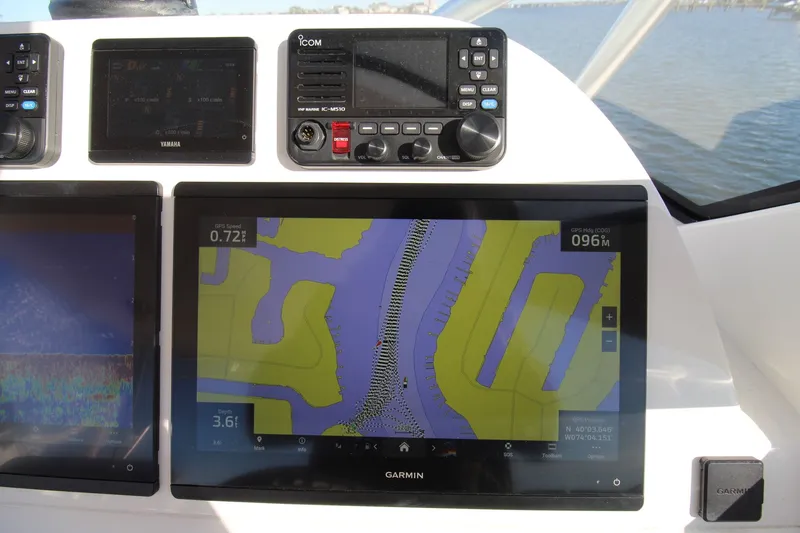 Slide: The Image of Navigation system on 2022 Albemarle 30 Express boat, featuring Garmin and Icom displays. - 29