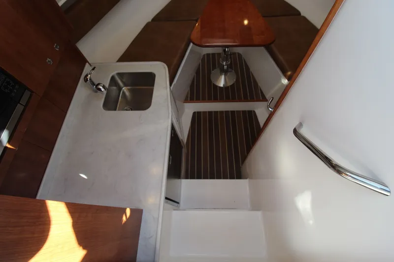 Slide: The Image of 2022 Albemarle 30 Express interior with sink, countertop, and seating area. - 31