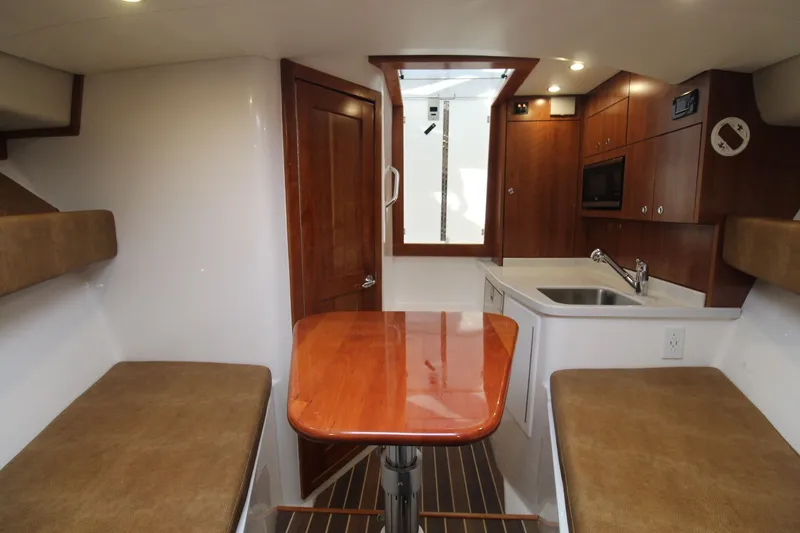 Slide: The Image of Interior of 2022 Albemarle 30 Express boat with seating, table, and kitchenette. - 36