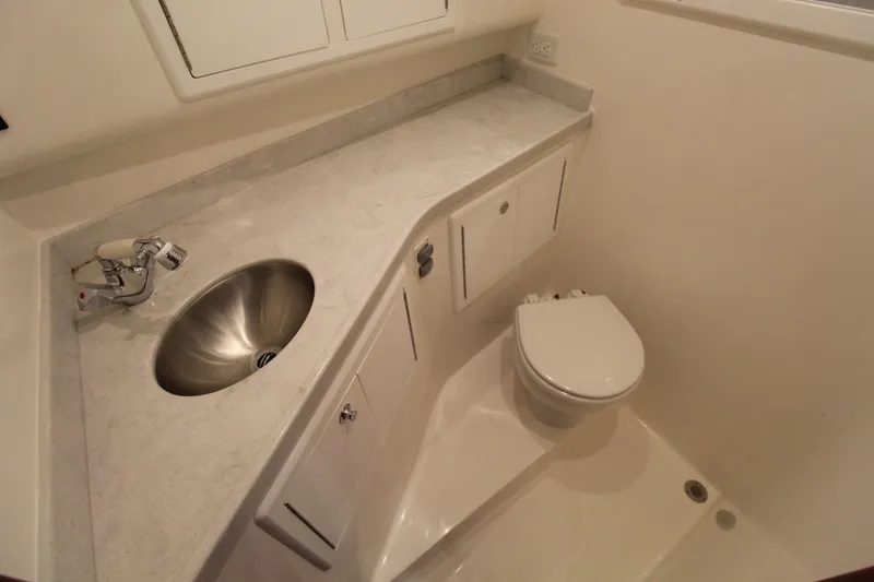 Slide: The Image of 2022 Albemarle 30 Express boat bathroom with sink, countertop, and toilet. - 40