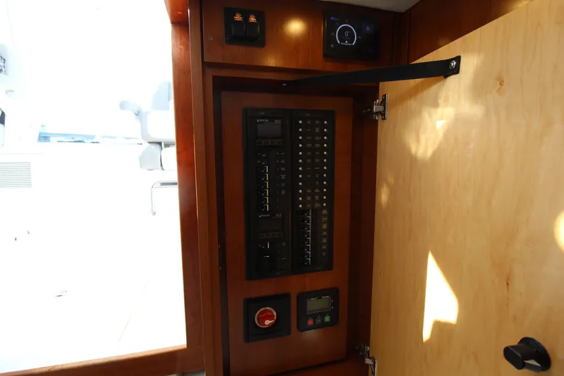 Slide: The Image of Electrical panel inside 2022 Albemarle 30 Express boat, featuring switches and controls. - 42