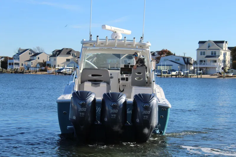 Slide: The Image of 2022 Albemarle 30 Express boat with triple 300 V6 engines on a sunny day. - 5