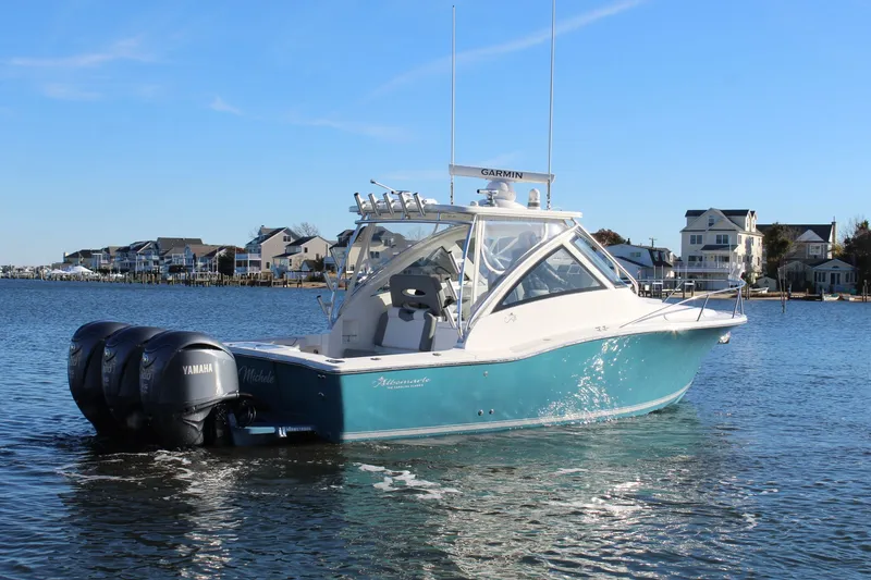 Slide: The Image of 2022 Albemarle 30 Express boat on water, featuring Yamaha engines, coastal houses in background. - 7