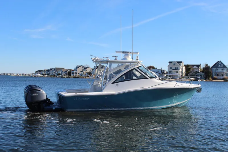 Slide: The Image of 2022 Albemarle 30 Express boat on water, with Yamaha outboard, near coastal homes. - 8