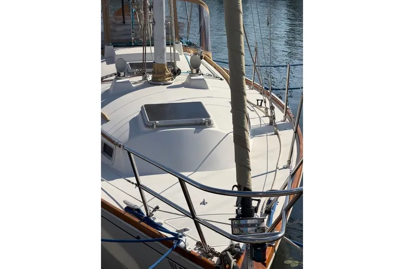 Slide: The Image of 1984 Sabre 34-1 sailboat docked, featuring sleek design and wooden accents. - 10