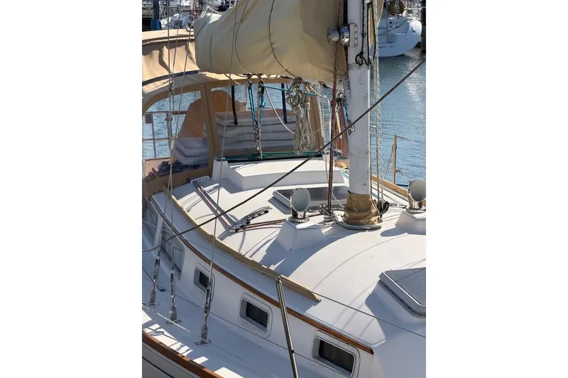 Slide: The Image of 1984 Sabre 34-1 sailboat docked at marina with covered sails. - 16