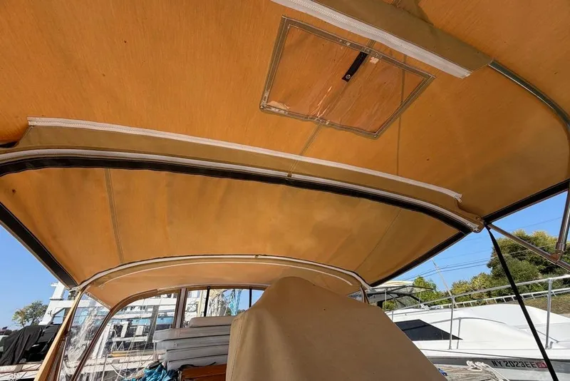 Slide: The Image of 1984 Sabre 34-1 sailboat cockpit with wooden hatch, ropes, and gauges. - 19