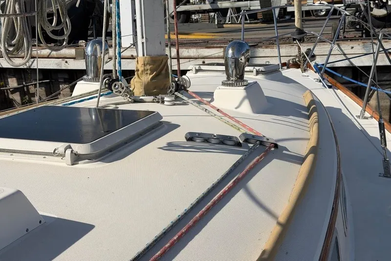 Slide: The Image of 1984 Sabre 34-1 sailboat deck with ropes and winches in a marina setting. - 24