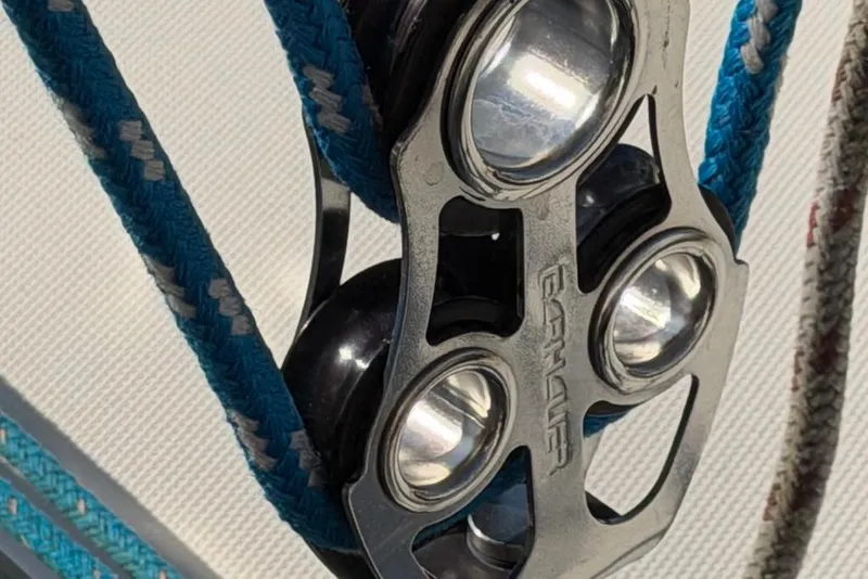 Slide: The Image of Close-up of a Sabre 34-1 sailboat pulley system, featuring blue ropes, 1984 model. - 32