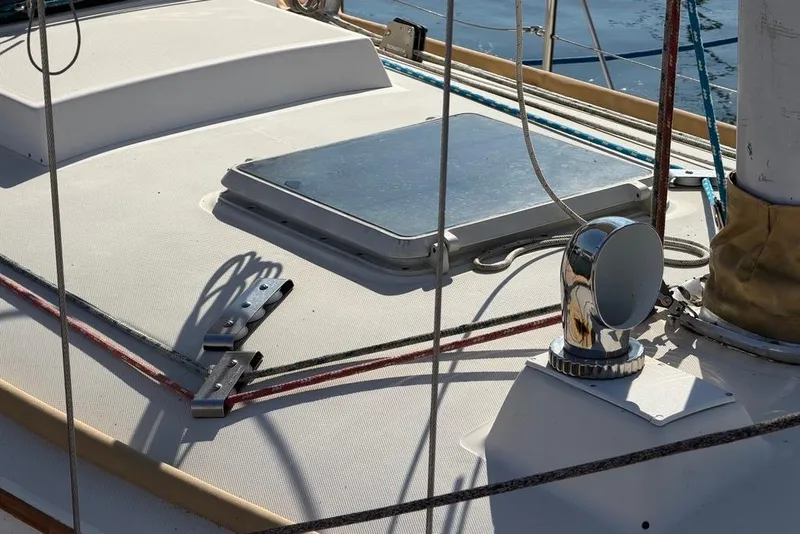 Slide: The Image of 1984 Sabre 34-1 sailboat deck with hatch and chrome vent in sunlight. - 35