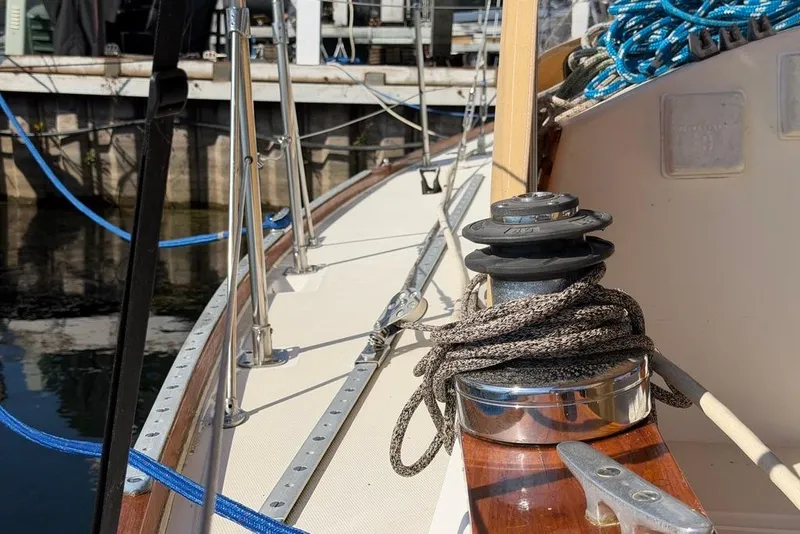 Slide: The Image of 1984 Sabre 34-1 sailboat deck with winch and ropes in marina. - 38