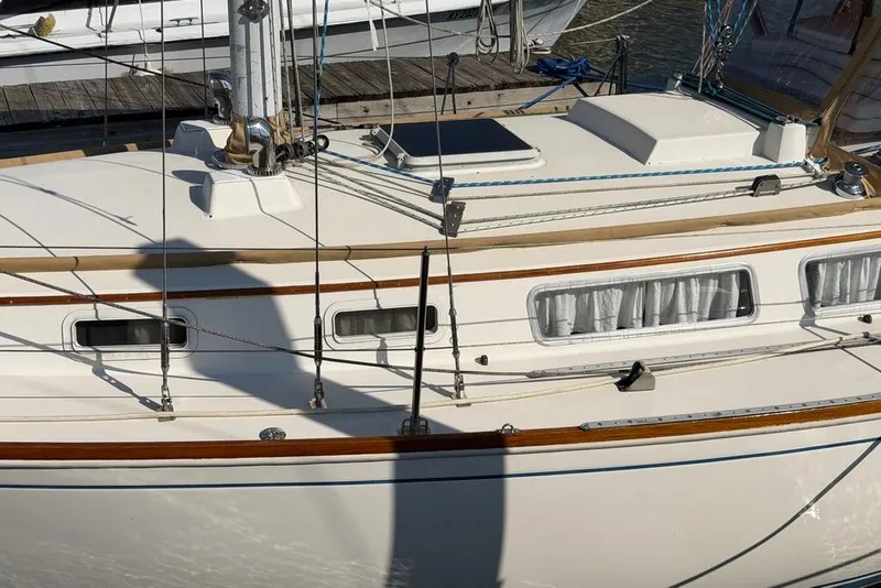 Slide: The Image of 1984 Sabre 34-1 sailboat with beige canvas cover docked at marina. - 4