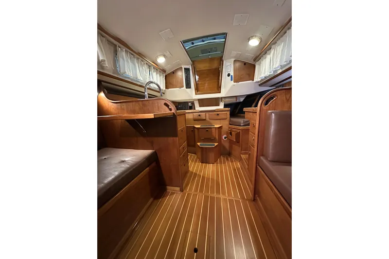 Slide: The Image of Interior of a 1984 Sabre 34-1 sailboat with wooden furnishings and seating. - 49