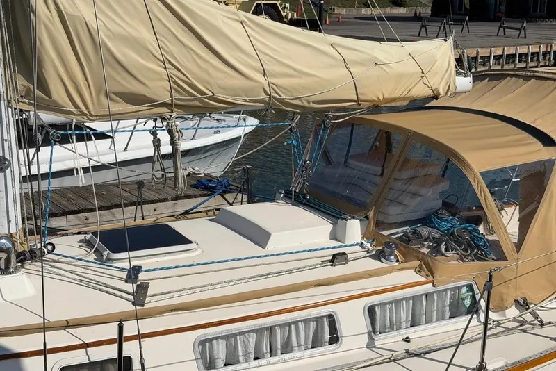 Slide: The Image of 1984 Sabre 34-1 sailboat docked in a marina, surrounded by other boats. - 5