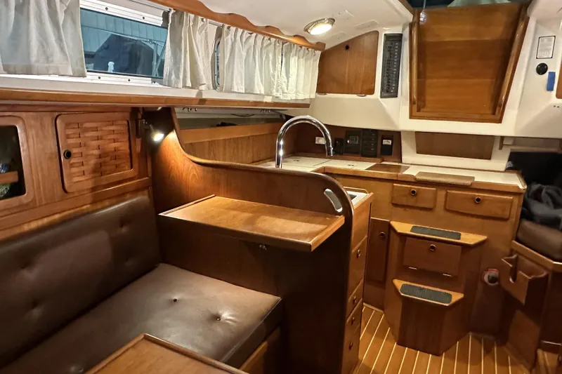 Slide: The Image of Interior of a 1984 Sabre 34-1 sailboat with wooden cabinetry and seating. - 51