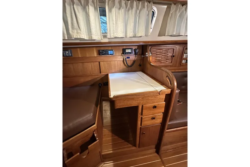 Slide: The Image of 1984 Sabre 34-1 yacht interior with wooden cabinetry and navigation station. - 52
