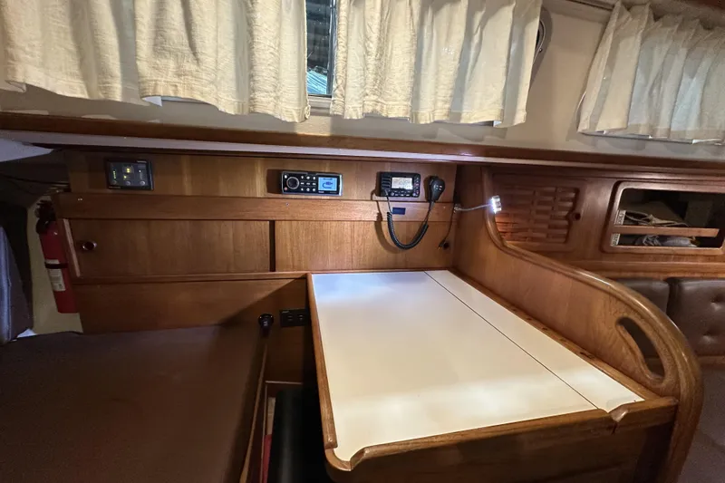 Slide: The Image of 1984 Sabre 34-1 yacht interior with navigation equipment and wooden cabinetry. - 53