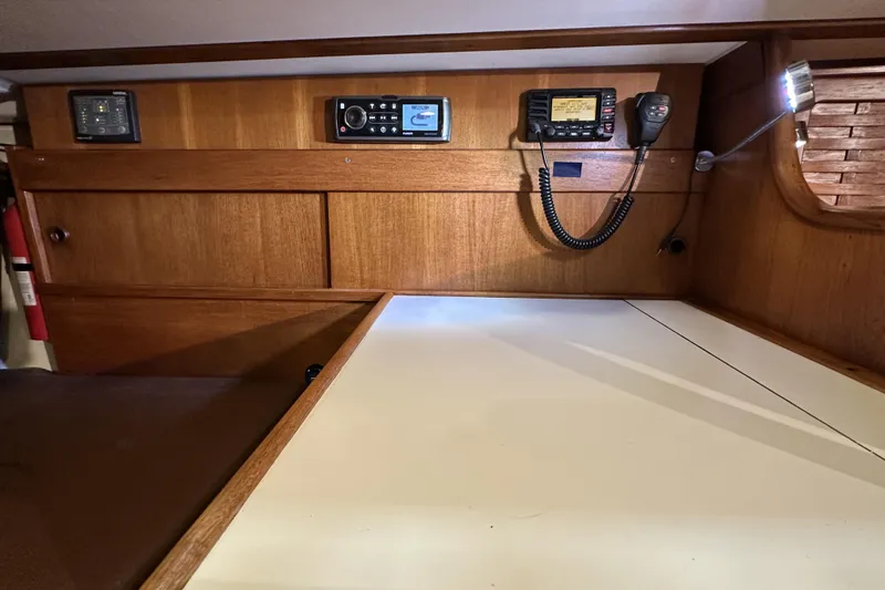 Slide: The Image of 1984 Sabre 34-1 yacht interior with navigation equipment and wooden cabinetry. - 54