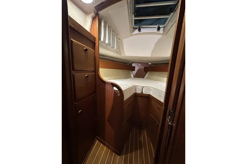 Slide: The Image of 1984 Sabre 34-1 yacht interior with wooden cabinetry and cozy sleeping quarters. - 57