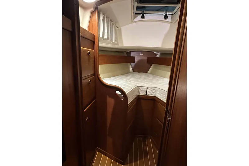 Slide: The Image of 1984 Sabre 34-1 yacht interior with cozy wooden cabin and comfortable bedding. - 59