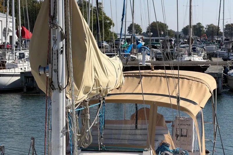 Slide: The Image of 1984 Sabre 34-1 sailboat with tan canopy docked in marina. - 6