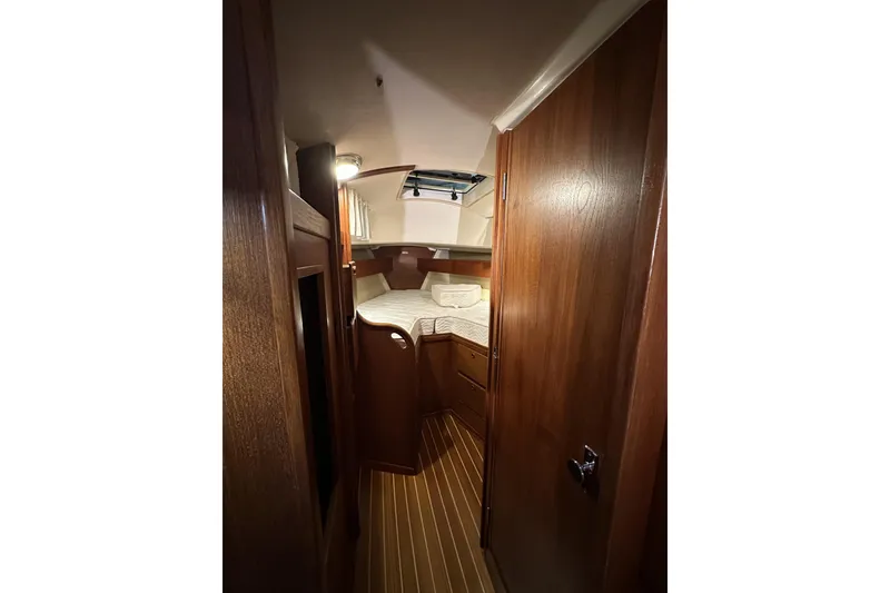 Slide: The Image of 1984 Sabre 34-1 yacht interior with wooden cabinetry and cozy sleeping area. - 60