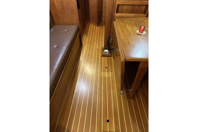 Slide: The Image of 1984 Sabre 34-1 yacht interior with polished wood flooring and seating. - 63