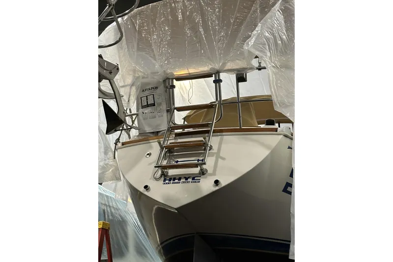 Slide: The Image of 1984 Sabre 34-1 sailboat stern view in storage, covered with protective plastic. - 71